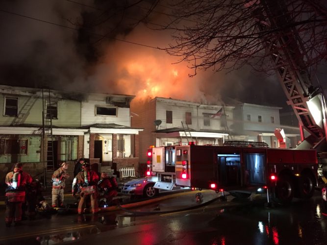 Photo Provided More than 40 firefighters battles a blaze that damaged a row of houses Monday morning on Virginia Street on Wheeling Island. No one was hurt by the fire, though two families were displaced.